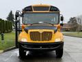 A 2013 International 3000 school bus with a yellow and black exterior, featuring large front windows and multiple lights on the roof