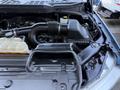 Close-up of the engine compartment of a 2021 Ford F-150 featuring the air intake and coolant reservoir