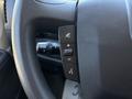 Close-up of the steering wheel control panel of a 2016 RAM Promaster featuring buttons for volume and voice command