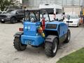 A blue 2020 Genie GTH-5519 rough terrain forklift with large tires a safety light and a small fire extinguisher mounted on the side