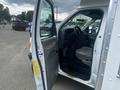 A 2004 Ford Econoline with the driver's door open revealing the interior and driver's seat