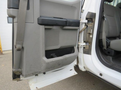 A close-up of the interior door panel of a 2017 Ford F-250 SD showing the armrest and storage area with visible wear and tear