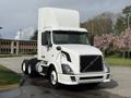A 2012 Volvo VNL truck with a white exterior and a sleek design featuring a tall cab and a spacious chassis for hauling cargo
