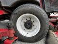 A close-up of a white wheel and tire from a 2012 Toro Groundsmaster showing the tread and hub assembly