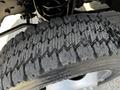 Close-up of a rugged tire from a 2016 Ford F-550 showing detailed tread design and signs of wear