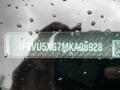 The image shows a close-up of a vehicle identification number (VIN) sticker for a 2021 Ford Transit with water droplets on the surface