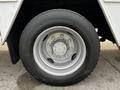 A silver wheel with multiple bolts on a 2006 GMC C5000 vehicle
