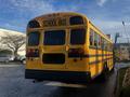 2005 Blue Bird 48 Passenger Bus with a yellow exterior and black stripes featuring school bus signage on the back