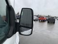 A 2017 Ford Transit van with rain on its side mirror in focus