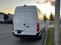 A white 2019 Mercedes-Benz Sprinter van viewed from the rear with a smooth design and red taillights