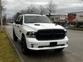 A 2022 RAM 1500 Classic in white with a black grille and accents parked on the side of the road