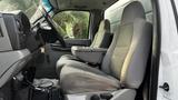 Interior view of a 2007 Ford F-550 showcasing front seats with a center console and a dashboard partial view