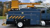 A blue 2009 International 4300 bucket truck with a yellow bucket on the side and various utility storage compartments