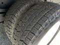 Close-up of two thick tires mounted on the rear of a 2007 GMC W3500 showcasing tread patterns and sidewalls