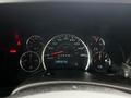 Dashboard of a 2019 Chevrolet Express showing speedometer fuel gauge and warning lights with the odometer reading 335712 km and a temperature indicator
