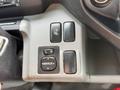 A close-up view of the control panel in a 2018 Hino 195 featuring buttons for mirror adjustment and the heated windshield