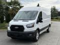 A white 2022 Ford Transit van with a black front grille and chrome accents facing forward with its doors closed and wheels visible