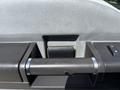 Close-up of the interior door handle of a 2012 Ford F-450 SD featuring a textured grip and a button for unlocking or locking the door