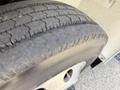 Close-up of a worn tire mounted on a 2011 International 4300 showing visible tread wear and sidewall details