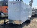 A white 2020 Mirage Enterprises 12 Foot Cargo trailer with a silver metal trim and a single axle parked on gravel