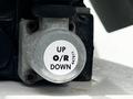 Close-up of a control valve on a 2012 Freightliner M2 106 with labels indicating UP O/R DOWN