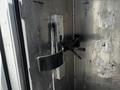 A close-up view of a metal fastening mechanism inside a 2009 Morgan Olson Workhorse vehicle with visible wear and scratches on the surface
