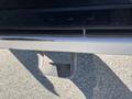 A close-up view of a step on a 2016 Ford F-250 SD with a textured surface and a silver metallic finish