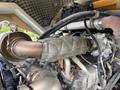 Close-up of a 2020 Hyundai HR110C engine with visible exhaust components and heat insulation wrapped around the exhaust pipe