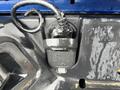A black electrical connection socket mounted on the tailgate of a 2019 RAM 1500 Classic with a coiled wire attached