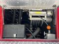 View of the interior compartment of a 2006 Emergency One Fire Truck showing hoses pumps and equipment used for firefighting