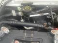 The engine compartment of a 2004 Ford Econoline featuring various hoses and components including a yellow cap labeled washer fluid