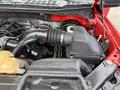 Close-up of the engine compartment of a 2015 Ford F-150 showing the air intake system and various engine components