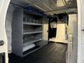 Interior view of a 2007 Ford Econoline van featuring metal shelving units and a spacious cargo area