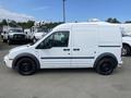 A white 2013 Ford Transit Connect van is parked with a plain side view showing its sliding side door and black wheels