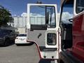 A 1994 Volvo FE 42 truck with its driver's side door open showcasing the interior and control panel