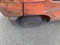 A red and rusted 2010 Toyota 7FGGU25 forklift with a worn front tire visible in the foreground