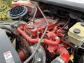Close-up of a Cummins engine with red components and visible hoses and wires in a 2018 Freightliner M2 106 truck