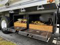 Two storage compartments at the rear of a 2017 International WorkStar 7600 with tools and equipment inside visible through open doors
