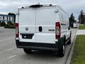 A 2018 RAM Promaster van viewed from the rear with a white exterior and standard rear doors
