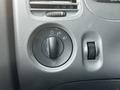 Control panel of a 2010 Ford Ranger showing the dashboard light switch with markings for off, parking lights, and headlights