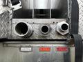 A close-up view of three shiny metal hose connections on a 2009 Spartan Gladiator fire truck with labels indicating use for crosslay and foam