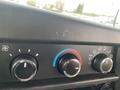 Dashboard controls of a 2018 Chevrolet Express showing climate control knobs and settings