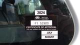 A black and white sticker displaying a certificate of approval for a 2014 International TerraStar with the number FY 52900 and expiration details for July and August 2024