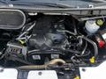 Engine compartment of a 2017 Ford Transit featuring the engine and various components such as hoses belts and a coolant reservoir