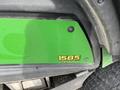A close-up view of a 2014 John Deere 1585 Terrain Cut machine displaying its model number and branding on a green panel