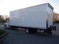 A white 2014 International Durastar box truck with a large cargo area and dual rear wheels positioned at an angle