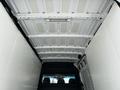 Interior view of the cargo area of a 2012 Mercedes-Benz Sprinter with a white ceiling and metal framework