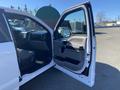 A 2019 Ford F-150 with the driver's side door open revealing the interior and dashboard