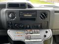 Dashboard of a 2016 Ford Econoline featuring a radio display heating controls and multiple buttons and switches