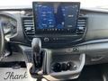 Dashboard of a 2022 Ford Transit showing a touchscreen display with navigation and a gear shift lever
